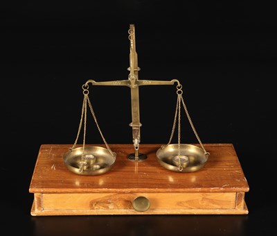 Lot 47 - Pharmacy scale with two scales on wooden cabinet.