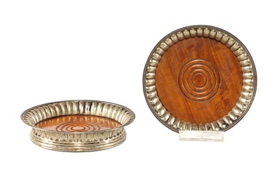 Lot 596 - A pair of English plate silver wine bottle coasters