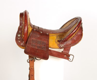 Lot 520 - Early leather saddle with leather and metal stirrups