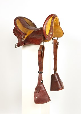 Lot 520 - Early leather saddle with leather and metal stirrups