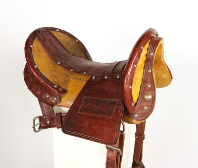 Lot 520 - Early leather saddle with leather and metal stirrups